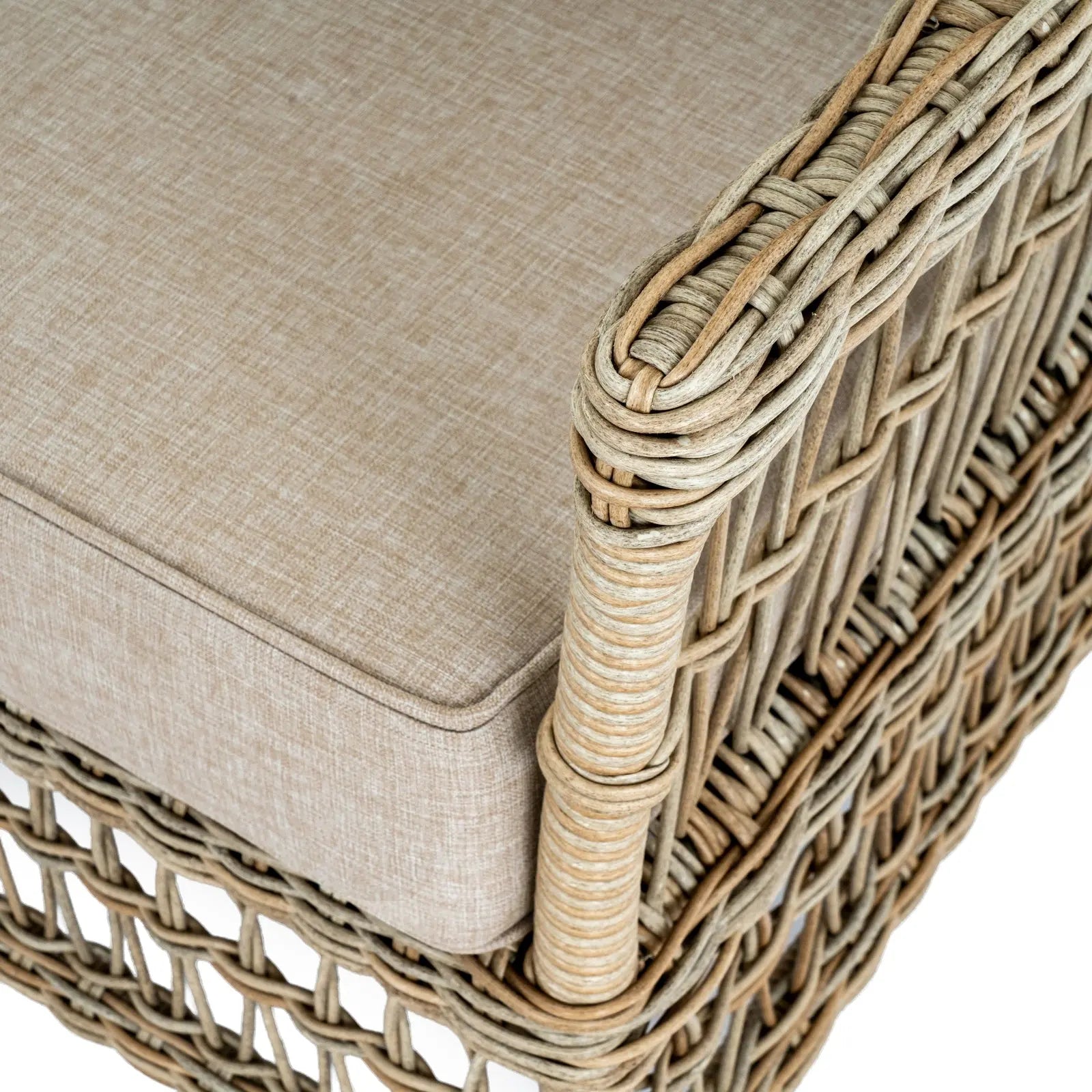 Wicker chair with beige cushion on a white background