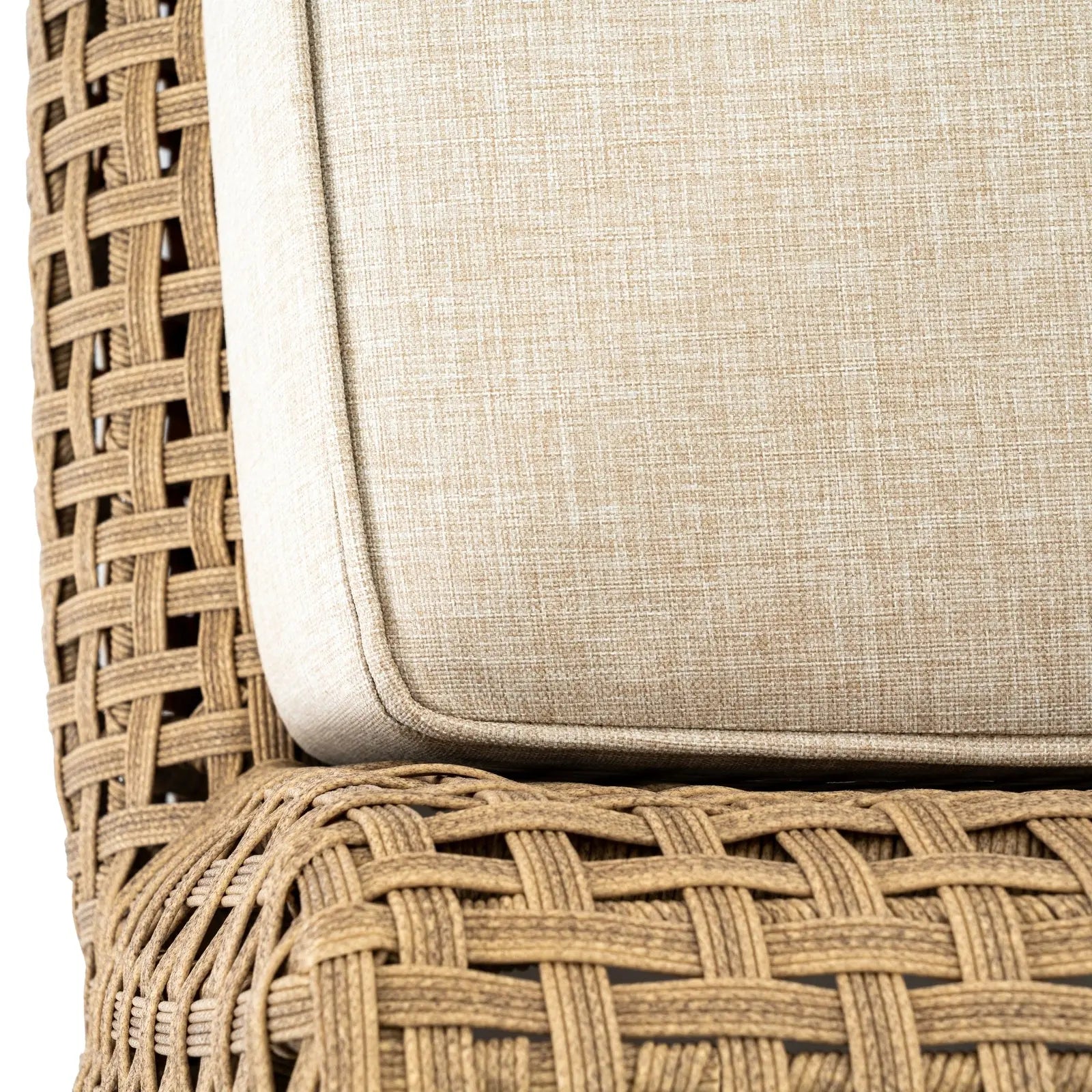 Close-up of a wicker chair with a beige cushion