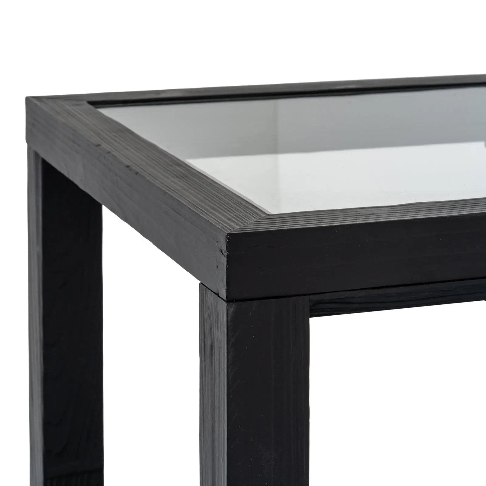 Close-up of a black metal table with a glass top on a white background