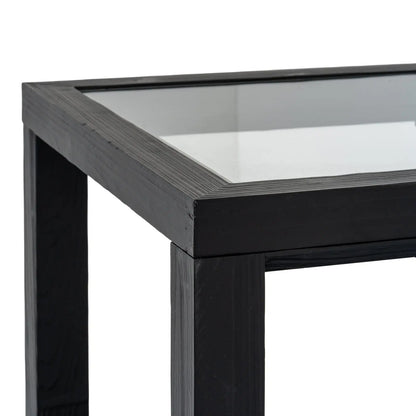 Close-up of a black metal table with a glass top on a white background