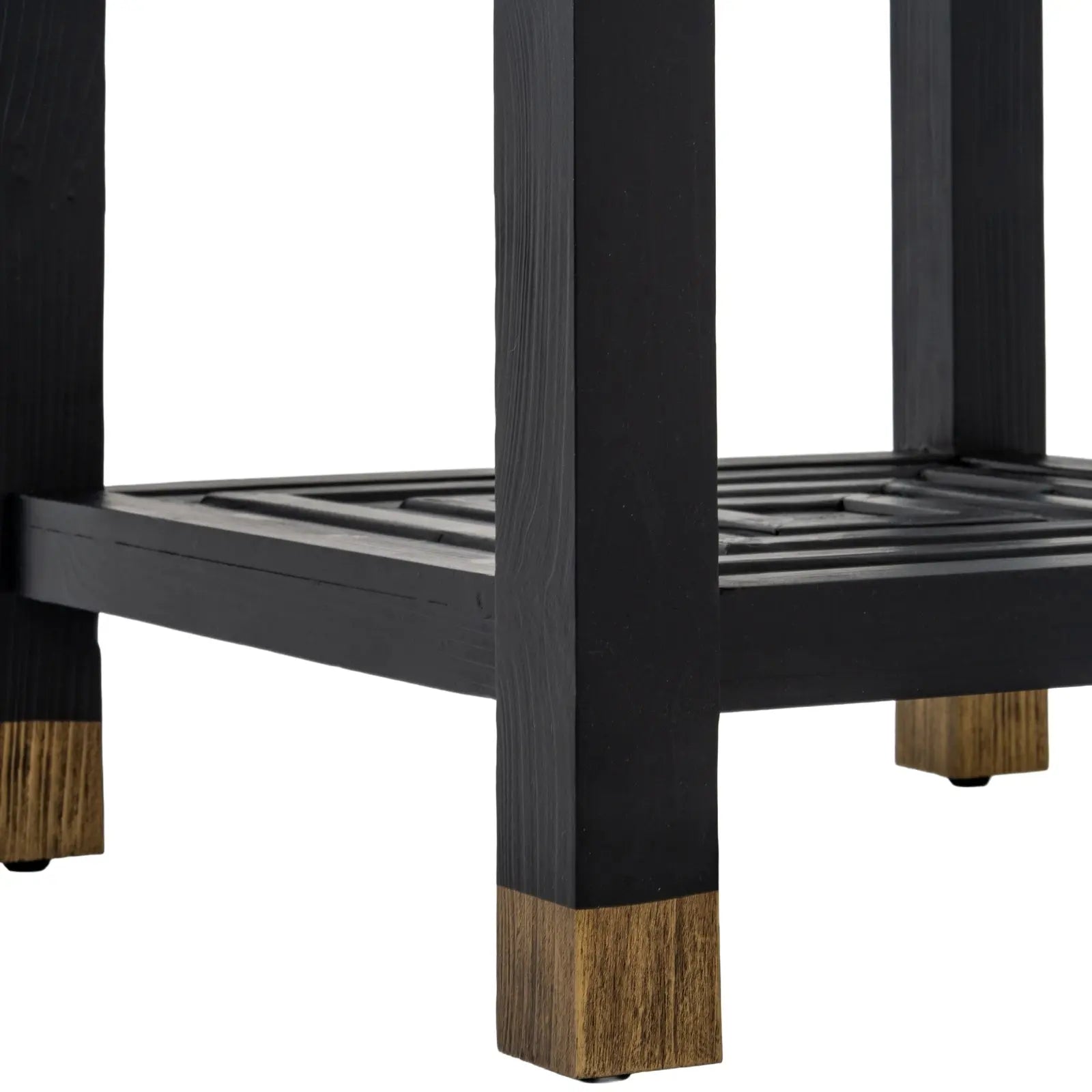 Close-up of a black metal frame with wooden feet on a white background