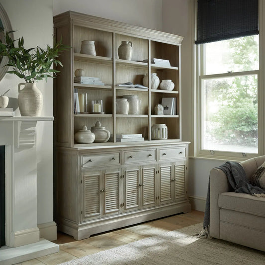 Wooden bookshelf with decorative items in a living room setting