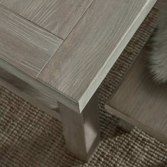 Close-up of a wooden table corner on a textured surface