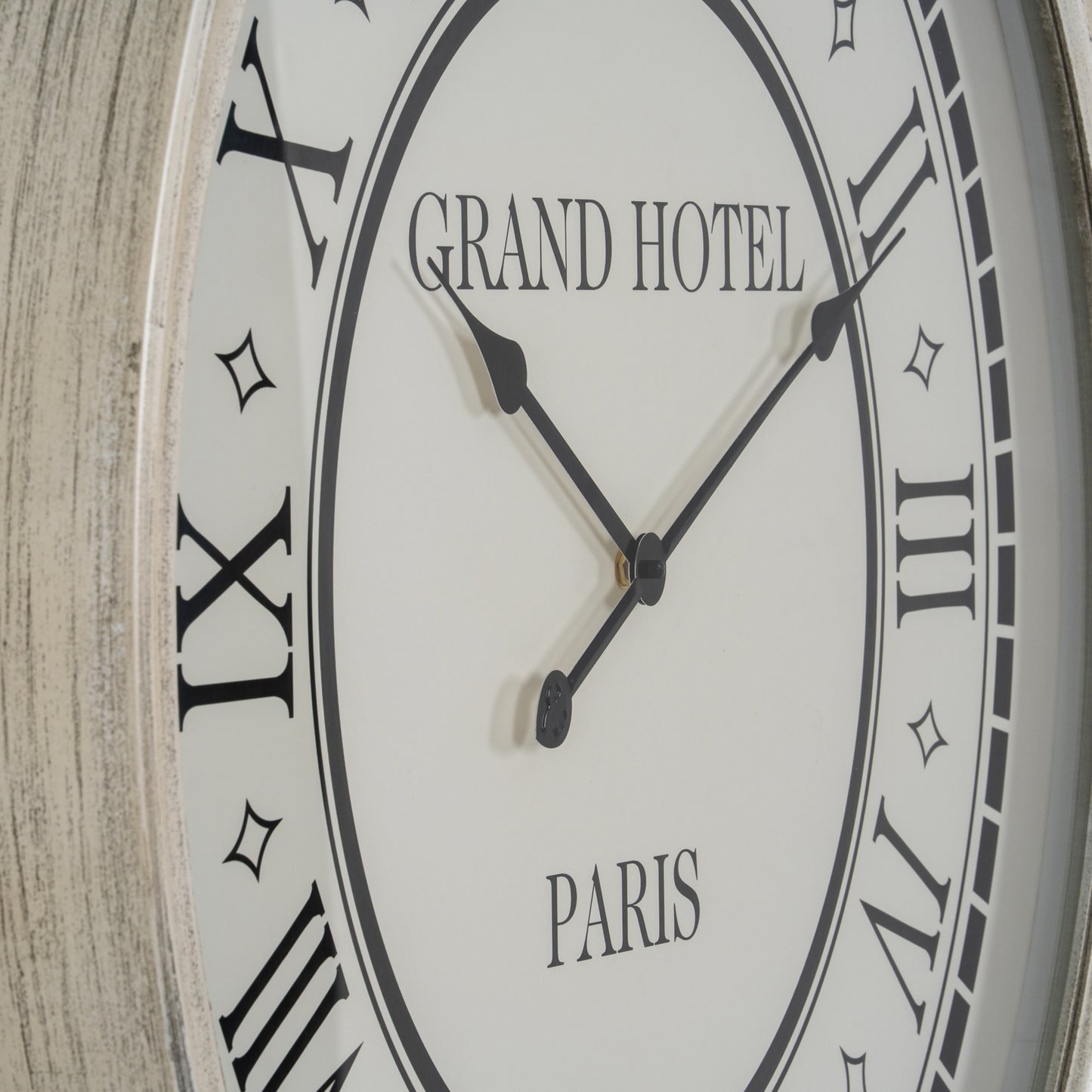 Wall clock with 'Grand Hotel Paris' text on a wooden background