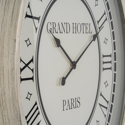 Wall clock with 'Grand Hotel Paris' text on a wooden background