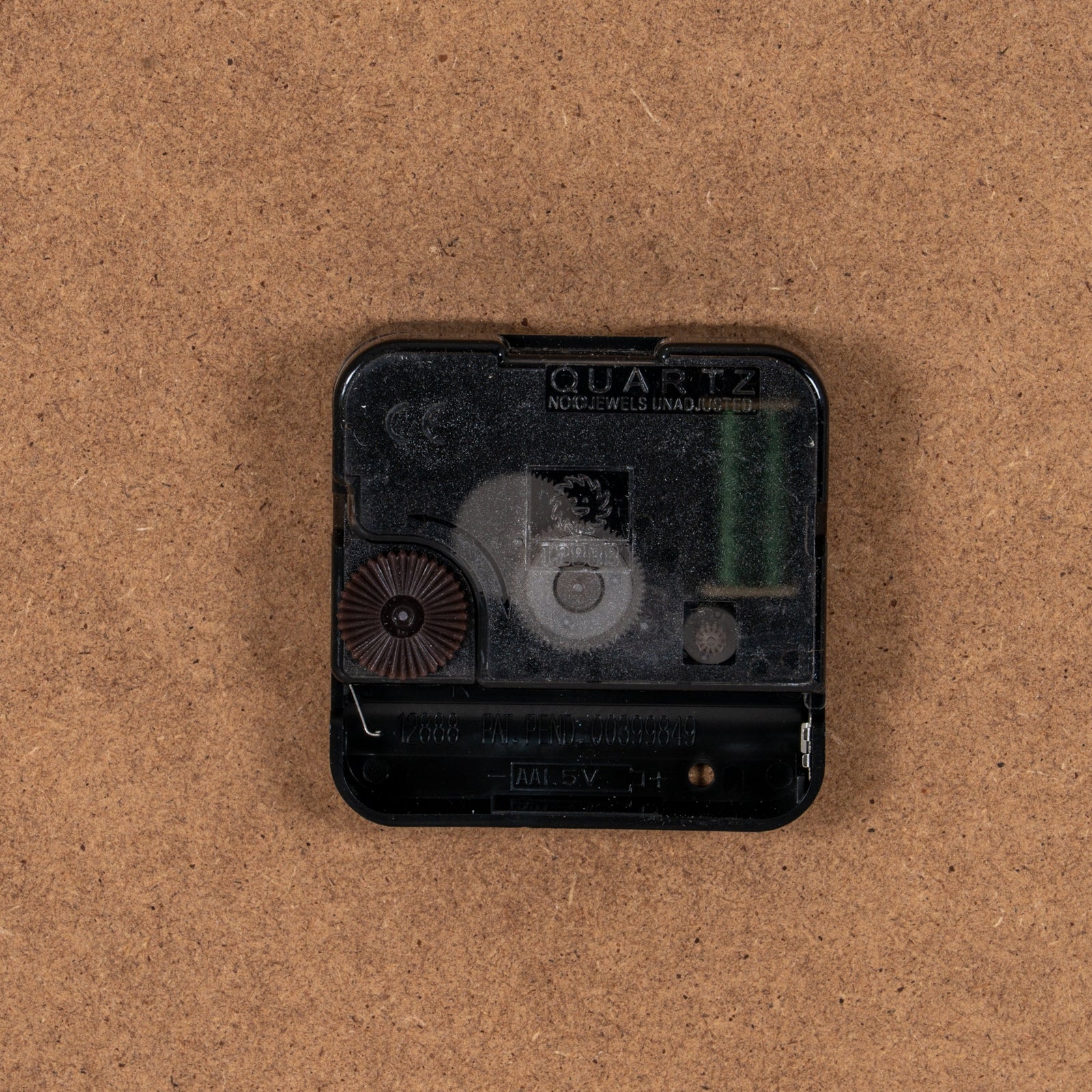 Quartz clock movement on a brown background