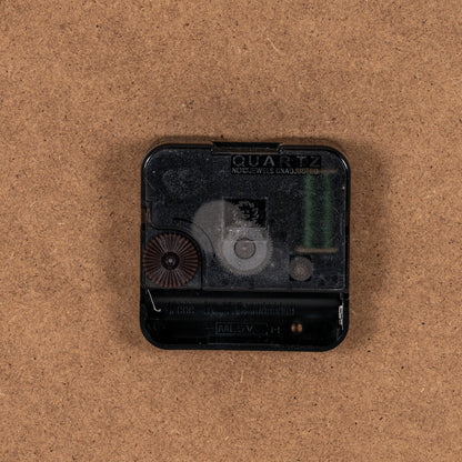 Quartz clock movement on a brown background