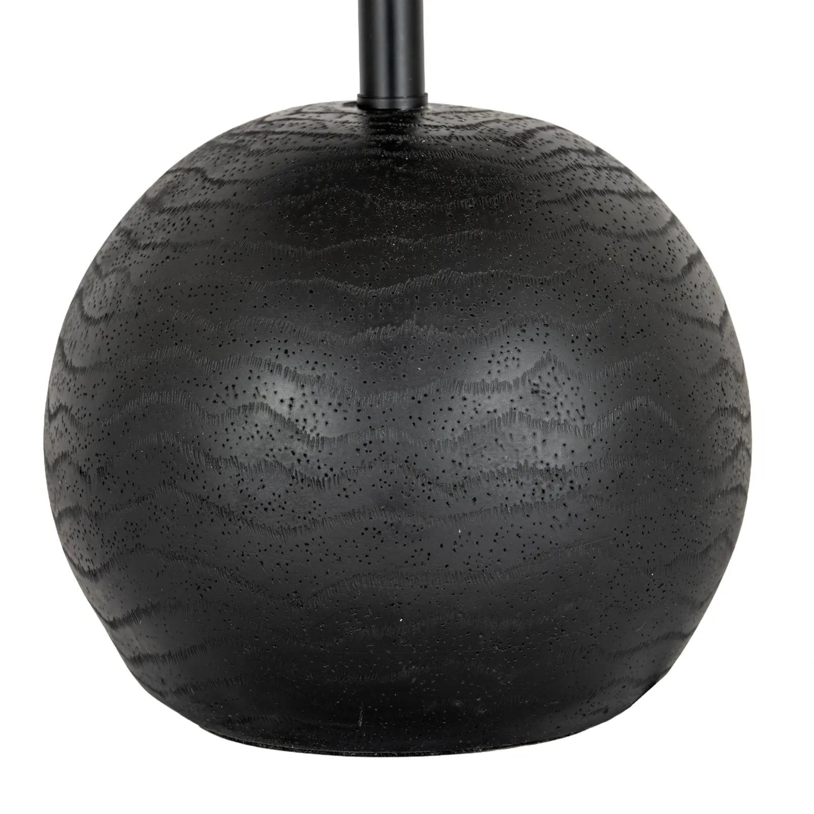 Black spherical object with textured surface on a white background