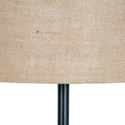 Close-up of a textured beige lampshade with a black base on a white background