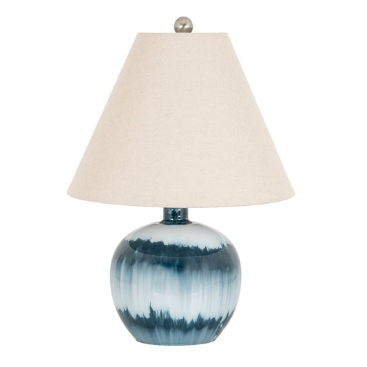Table lamp with blue ceramic base and beige lampshade on a white background