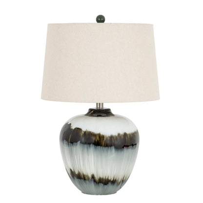 Table lamp with a ceramic base and beige lampshade on a white background