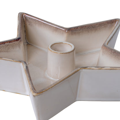 Ceramic star-shaped candle holder with a central cylindrical candle on a white background