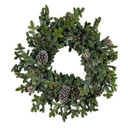 Green Christmas wreath with pine cones on a white background