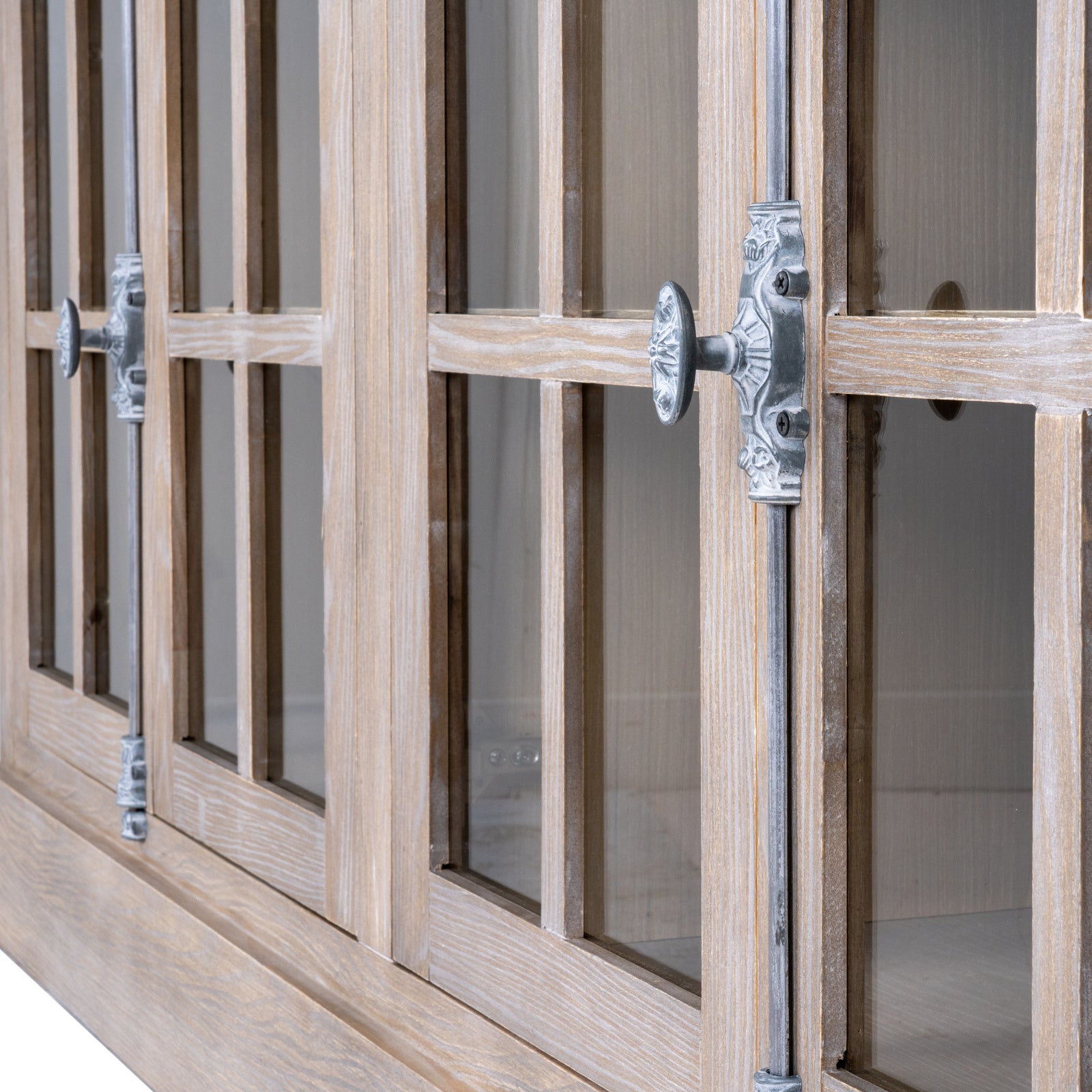 Wooden cabinet with glass panels and metal handles on a white background