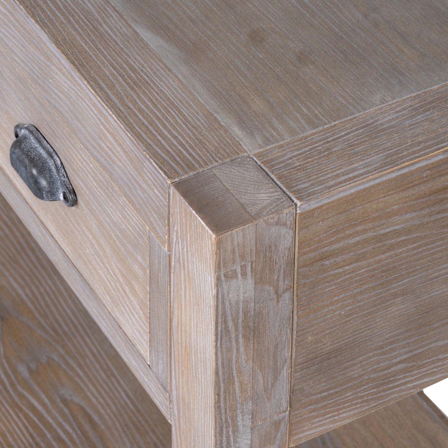Close-up of a wooden cabinet corner with a metal handle.