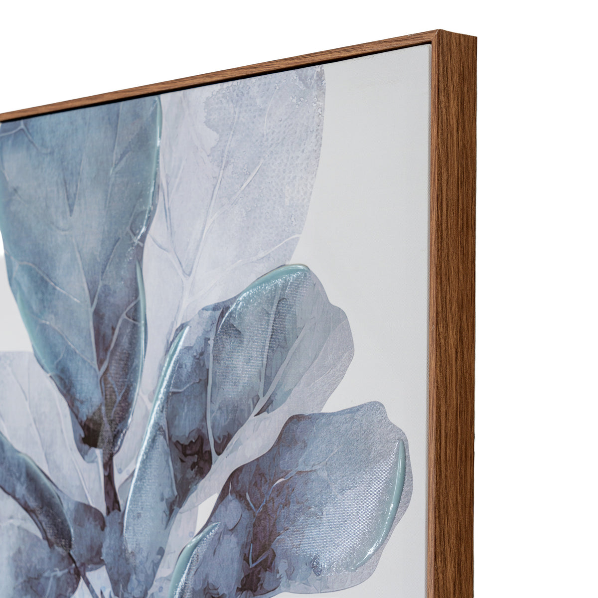 Close-up of a framed botanical wall art print showing large blue-gray leaves on a white background, with a medium brown wood frame visible on the right side.