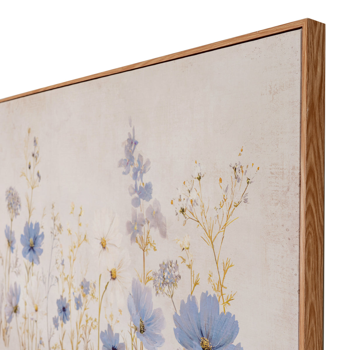 A close-up of a framed floral wall art print showing delicate blue and yellow wildflowers on a textured off-white background, with a light natural wood frame visible.