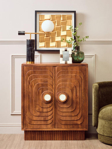 Wooden sideboard with decorative elements in a room setting