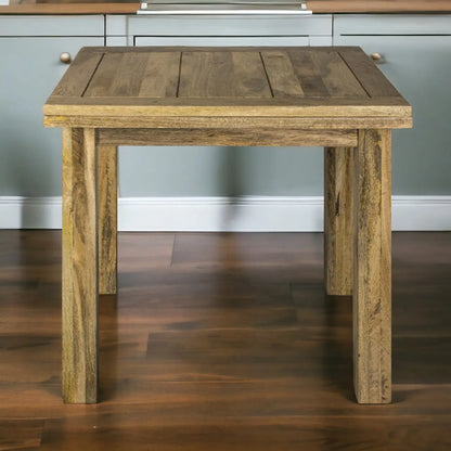 Wooden side table in a room with gray walls and wooden floor.
