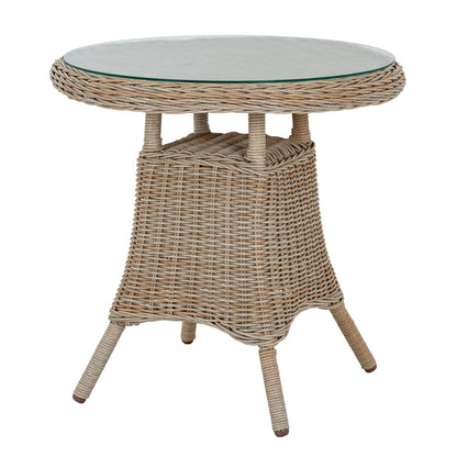 Round wicker side table with a glass top on a white background