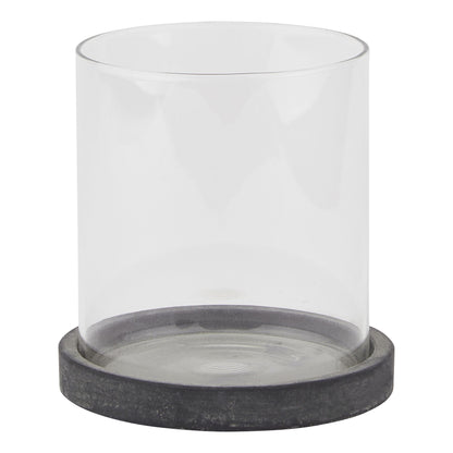Clear glass candle holder with a dark gray base on a white background