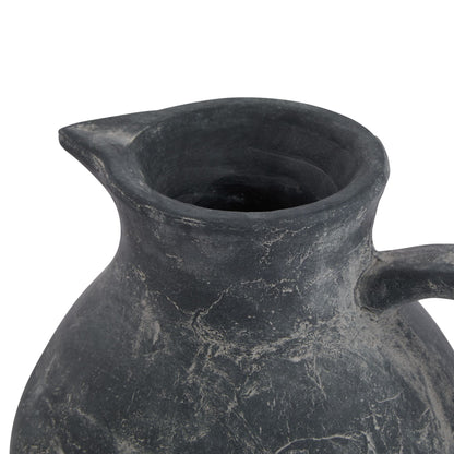 Black ceramic pitcher on a white background