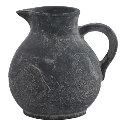 Black ceramic pitcher with handle on a white background