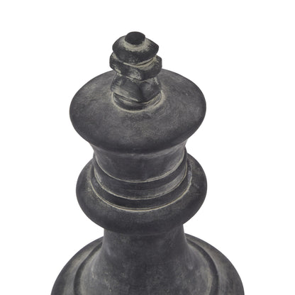Black chess piece, likely a king, on a white background