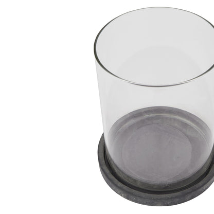 Clear glass container with black base on a white background