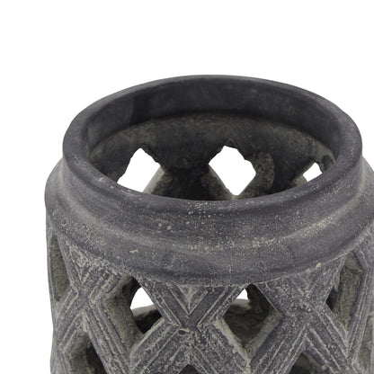 Close-up of a textured black ceramic vase on a white background
