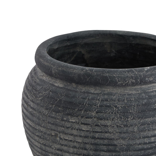 Black stone pot with textured surface on a white background