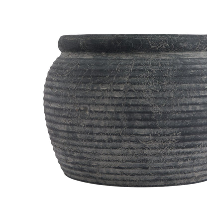 Textured black pot on a white background