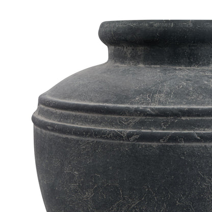 Close-up of a dark stone vase on a white background