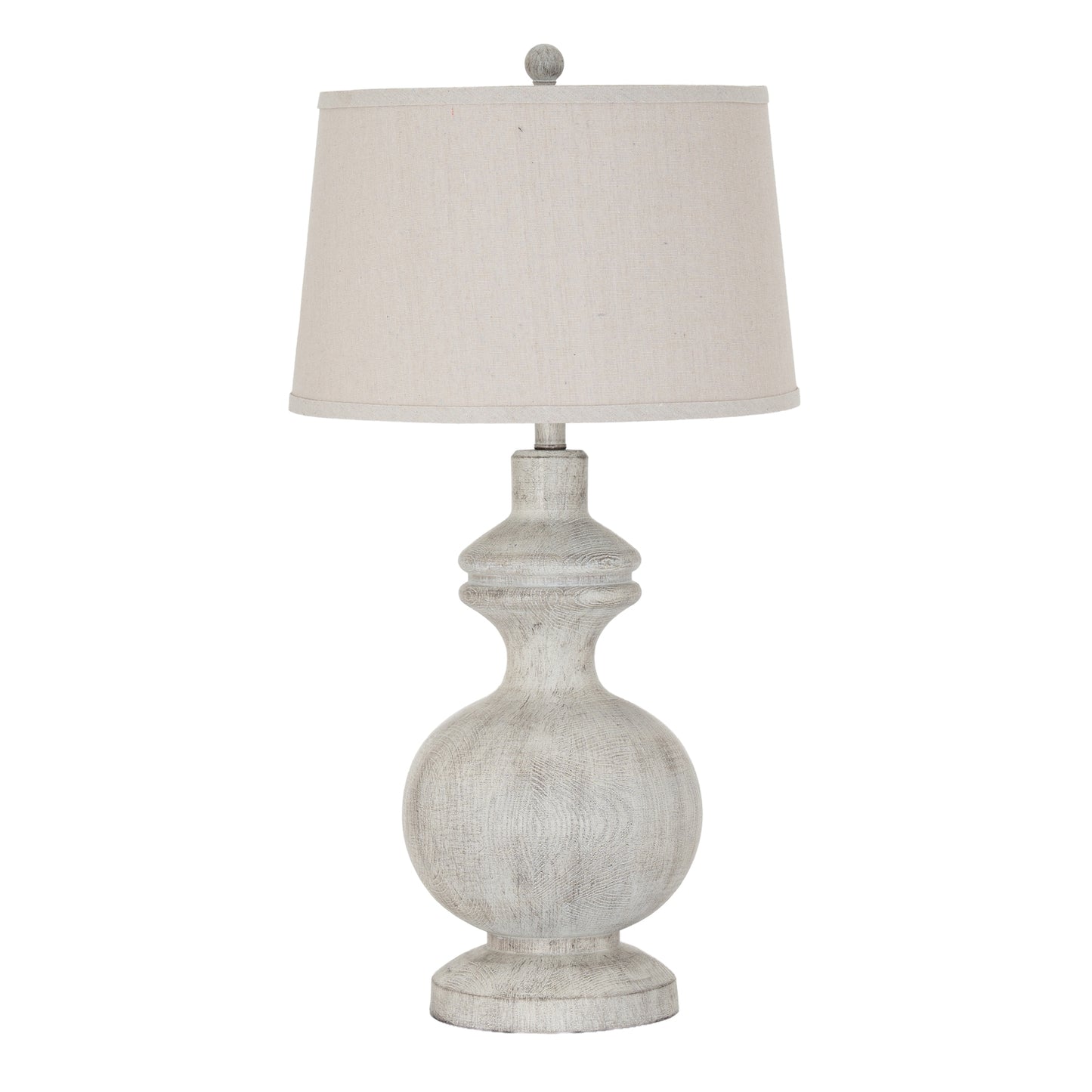 Table lamp with a textured base and white shade on a white background