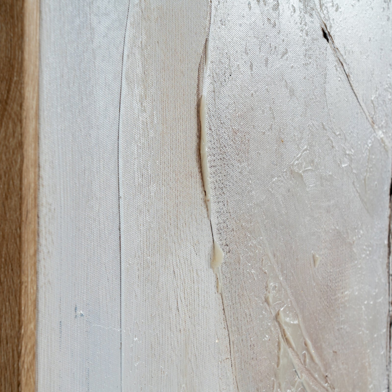 Close-up of a textured surface with a wooden edge