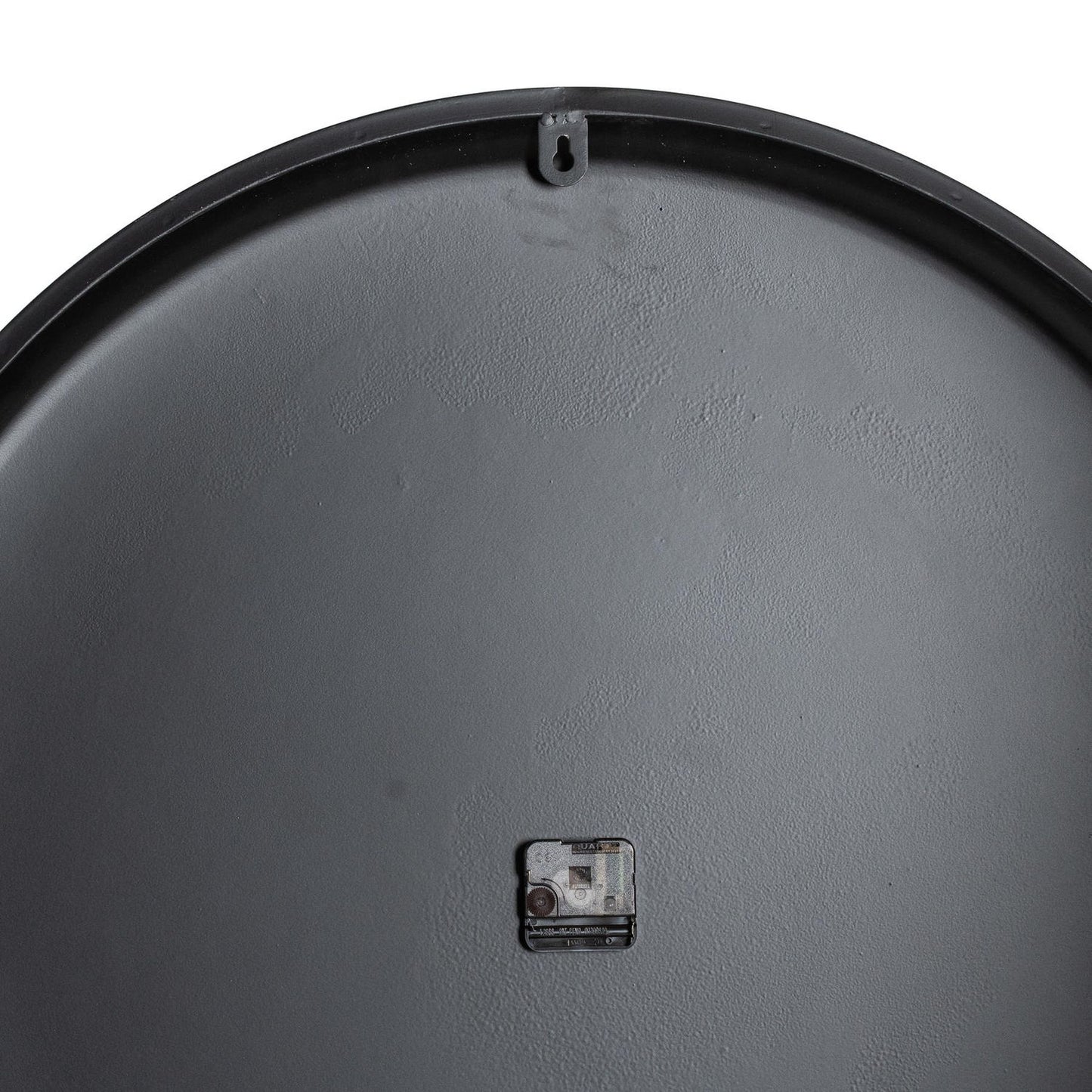 Close-up of a gray metal surface with a small rectangular component on a white background