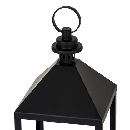 Black metal lantern with a handle on a white background