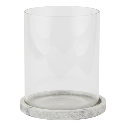 Clear glass candle holder with a gray marble base on a white background