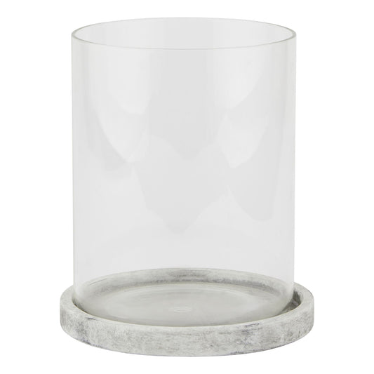 Clear glass candle holder with a gray marble base on a white background
