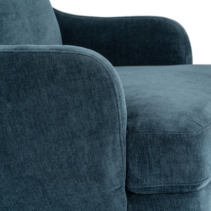Close-up of a blue textured sofa with a neutral background