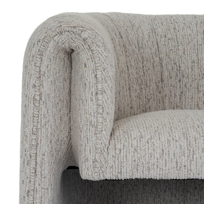 Close-up of a textured gray sofa armrest