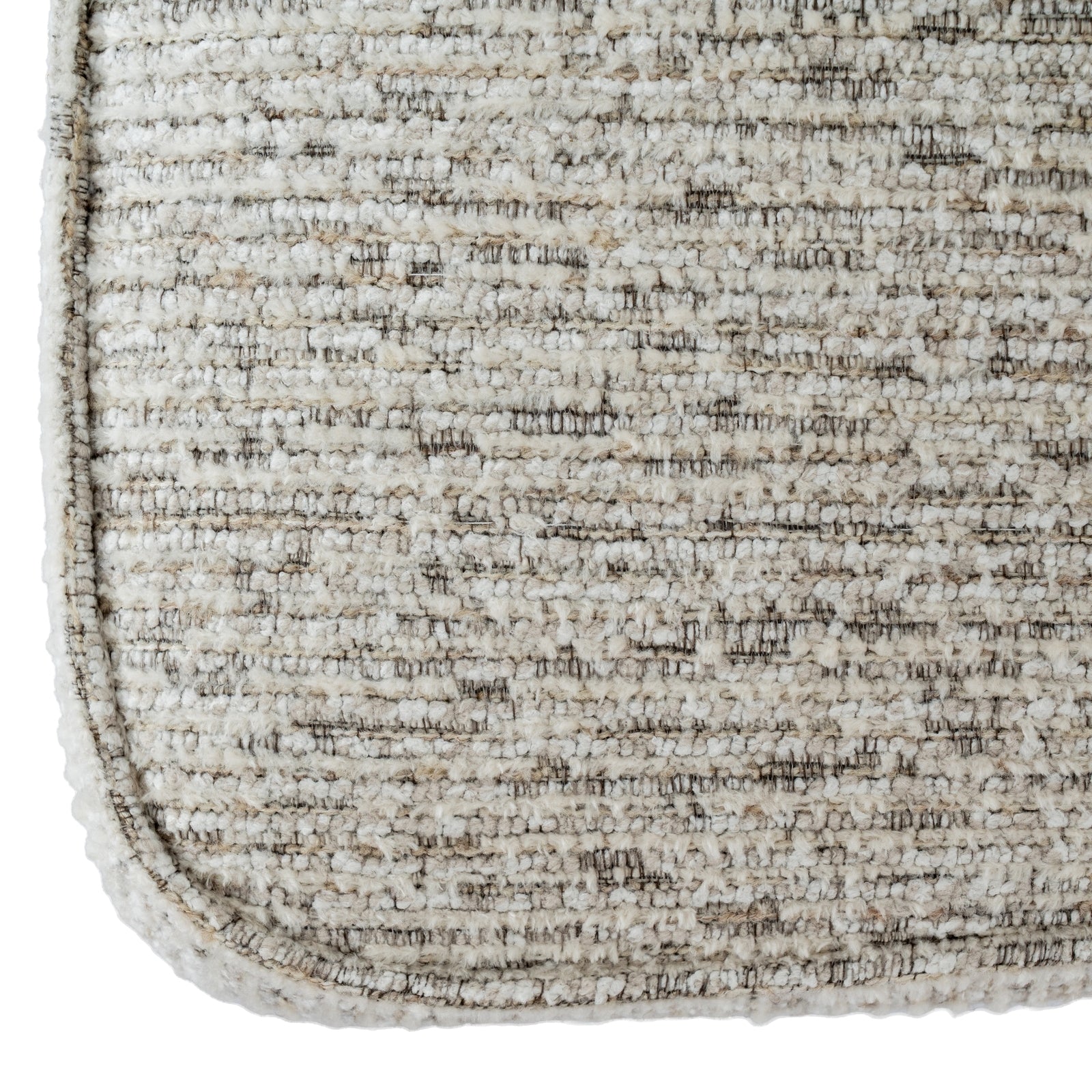 Close-up of a textured beige rug corner