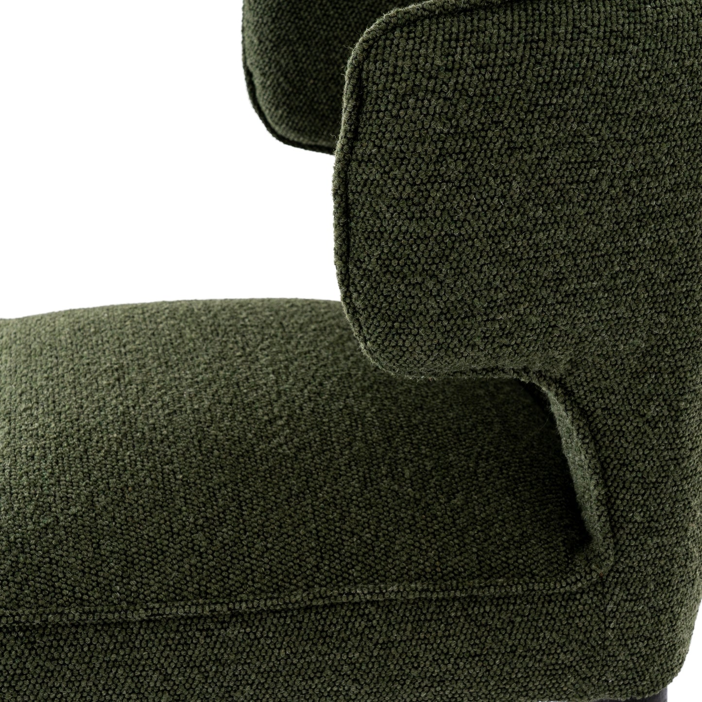 Close-up of a green upholstered chair with a textured fabric.