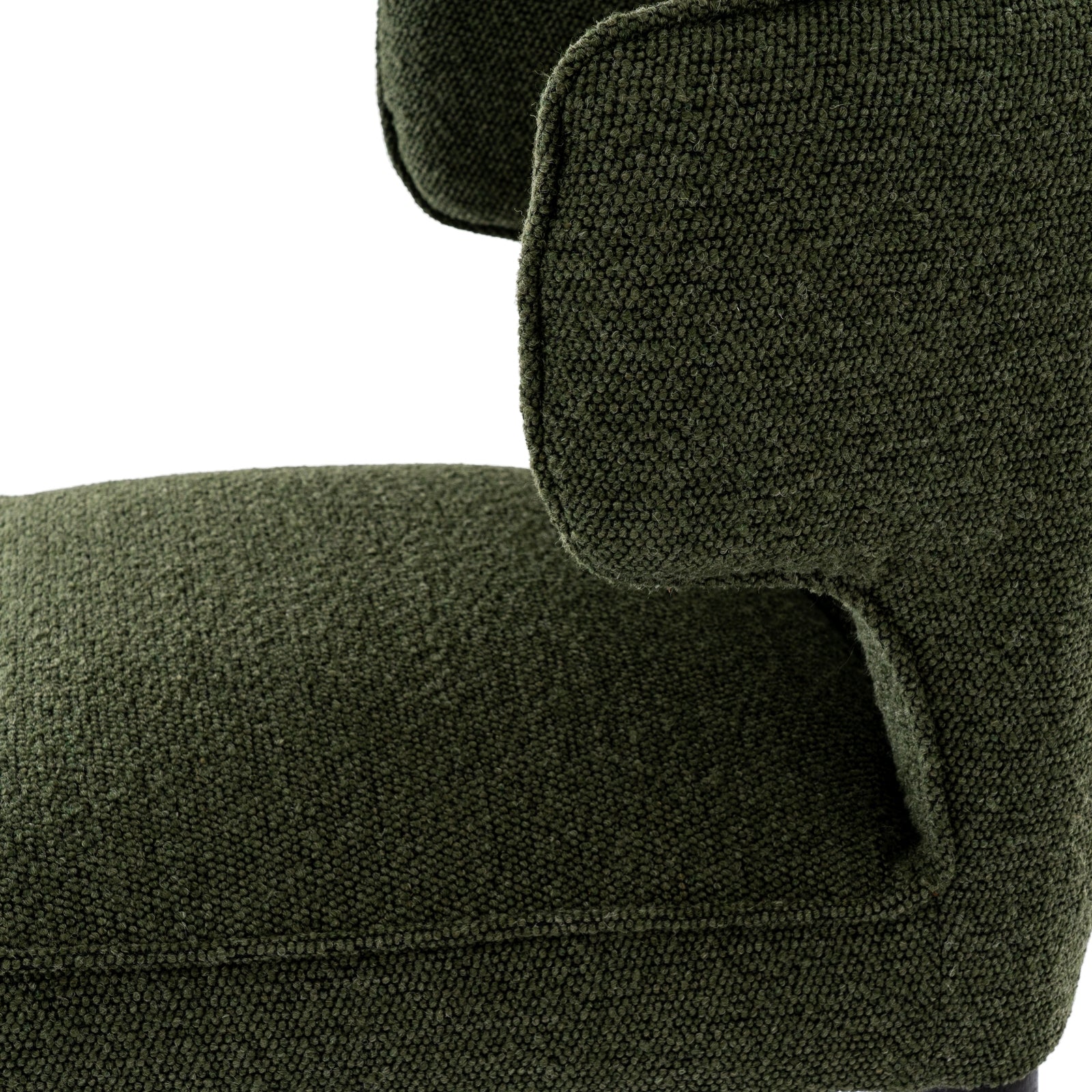Close-up of a green upholstered chair with a textured fabric.