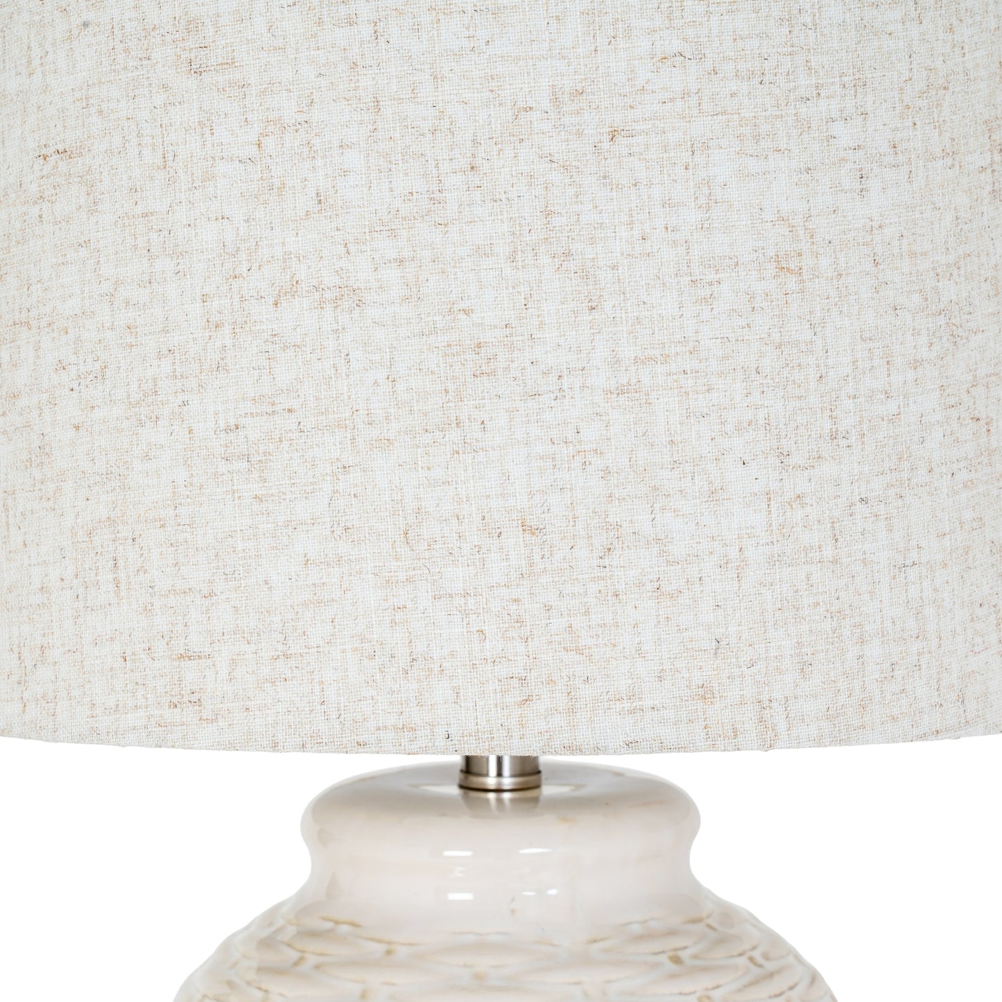 Close-up of a textured lampshade with a marble-like base.