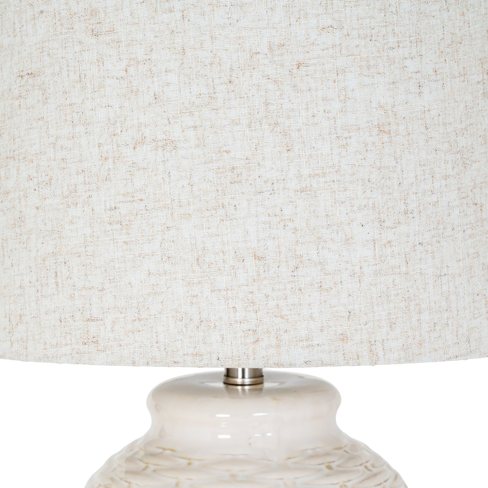 Close-up of a textured lampshade with a marble-like base.