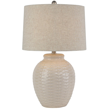 Table lamp with textured beige base and shade on a white background