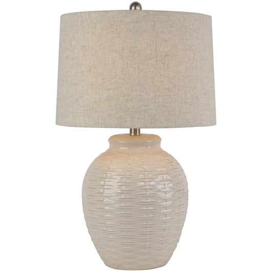 Table lamp with textured beige base and shade on a white background