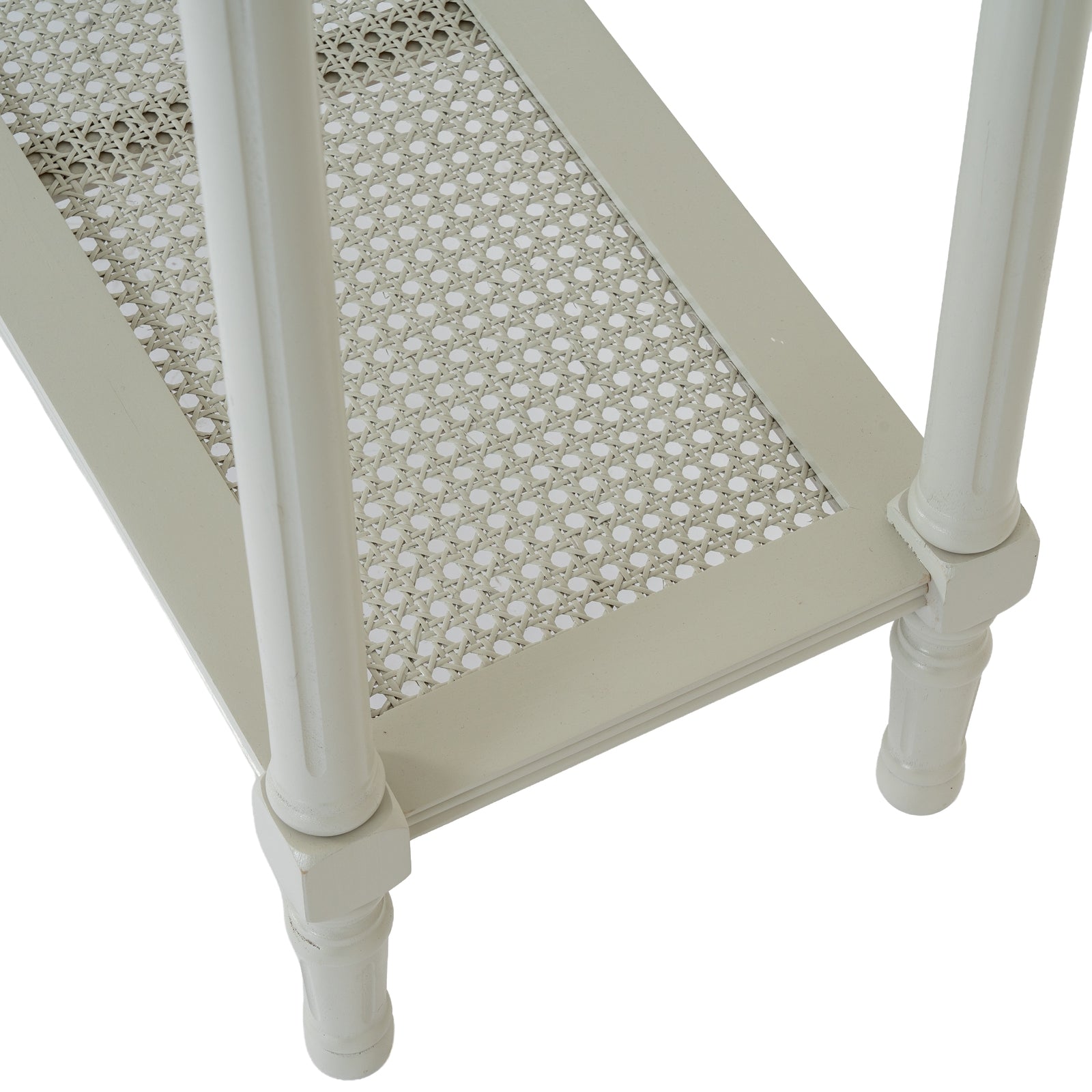 Small table with caned top and white legs on a white background