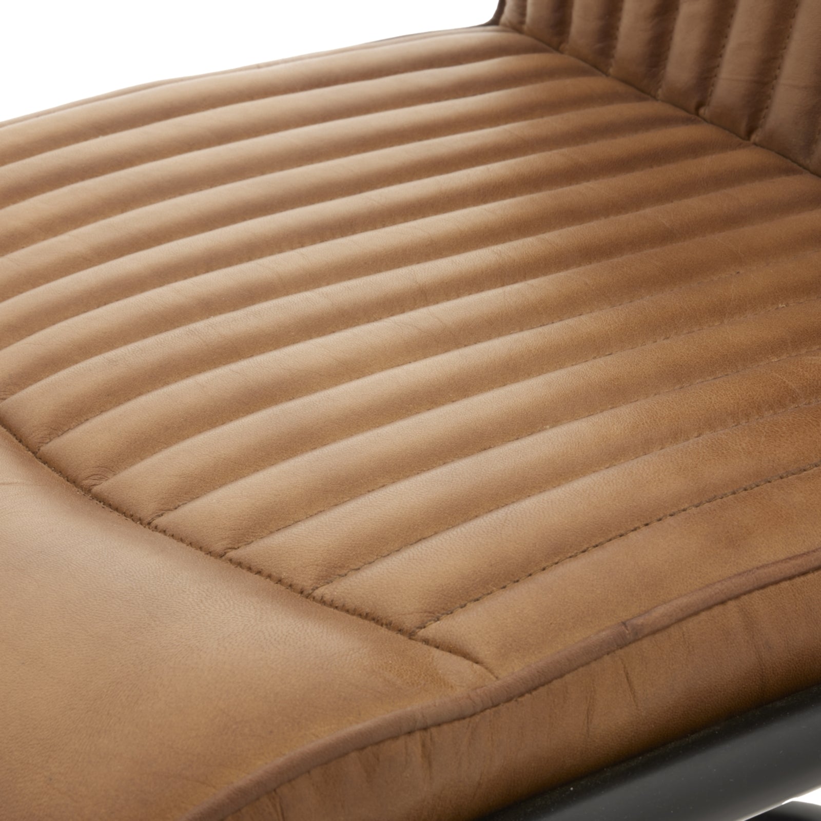 Close-up of a brown quilted seat cushion on a chair.